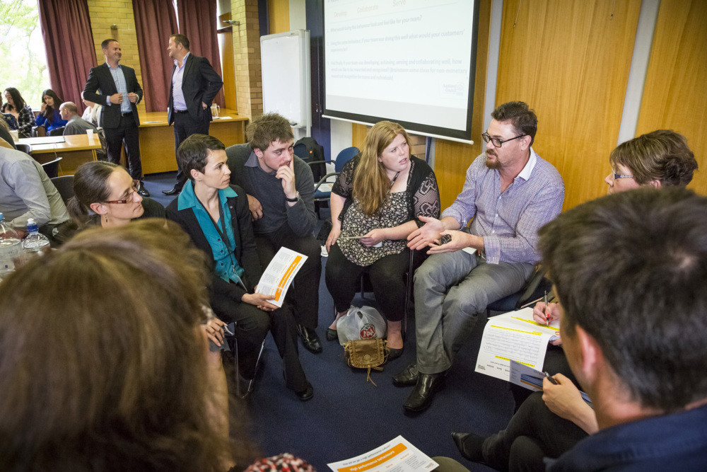 A group of people having a discussion indoors